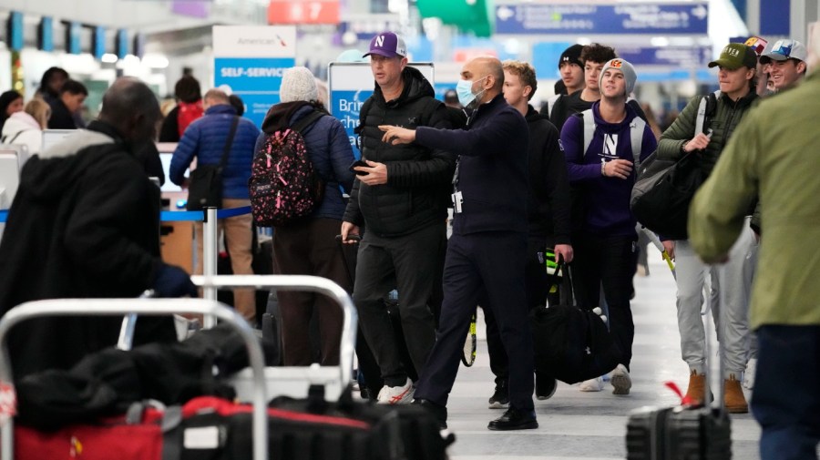 Travelers walk through Terminal 3 at the O'Hare International Airport in Chicago, Sunday, Jan. 14, 2024. Over 70 flight cancellations at Chicago airports Sunday.