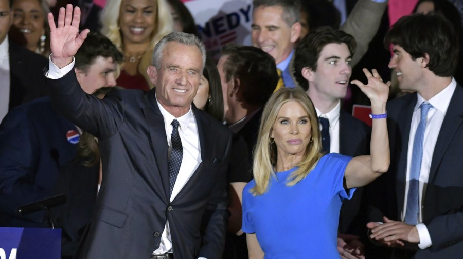 Robert F. Kennedy Jr. and wife Cheryl Hines wave with family members onstage at an event where announced his run for president on Wednesday, April 19, 2023, at the Boston Park Plaza Hotel, in Boston.