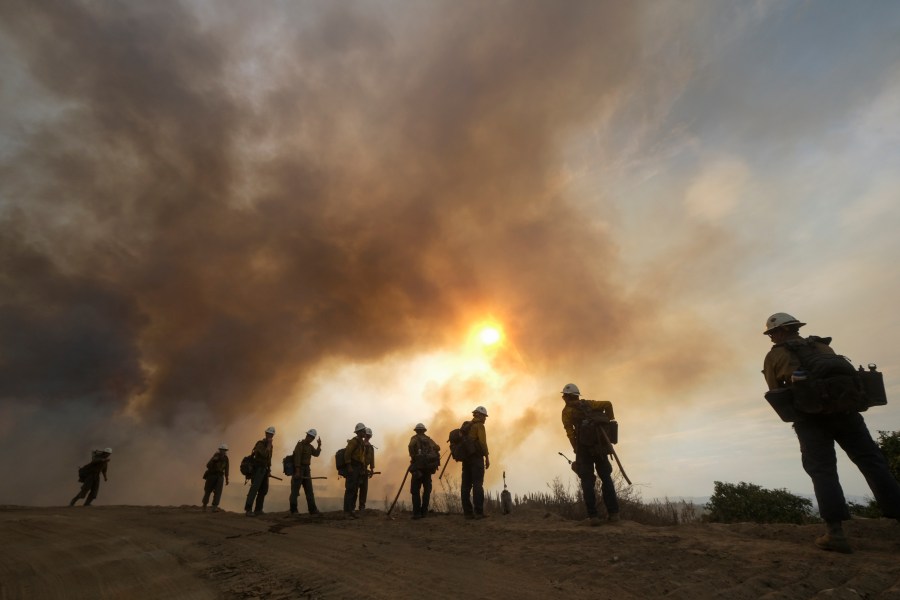 FILE - Firefighters watch as the Fairview Fire burns on a hillside, Sept. 8, 2022, near Hemet, Calif. (AP Photo/Ringo H.W. Chiu, File)