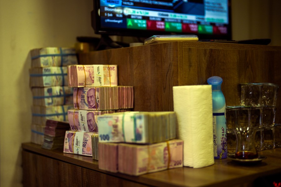 Turkish liras banknotes are piled in an exchange currency shop in Istanbul, Turkey, Monday, Feb. 5, 2024. Turkey has seen its fifth central bank leader depart in as many years as Hafize Gaye Erkan, the first woman in the top role, stepped down after just eight months in the job. (AP Photo/Francisco Seco)