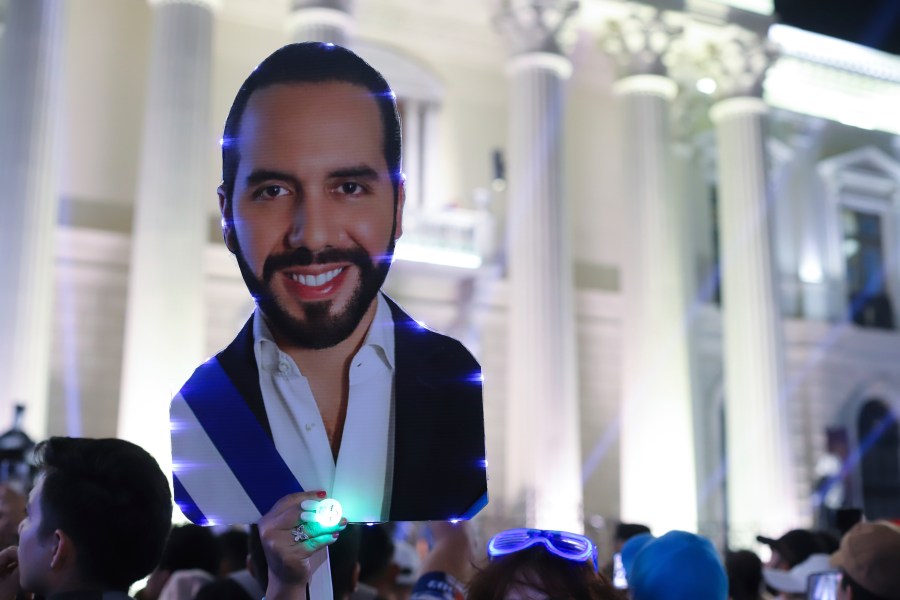 Supporters hold a cut of Salvador President Nayib Bukele, who is seeking re-election, as they gather to celebrate results of a general election at the Gerardo Barrios square in downtown San Salvador, El Salvador, Sunday, Feb. 4, 2024. (AP Photo/Salvador Melendez)