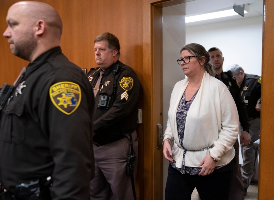 Jennifer Crumbley walks into the Oakland County courtroom of Judge Cheryl Matthews before being found guilty on four counts of involuntary manslaughter on Tuesday, Feb. 6, 2024 in Pontiac, Mich. Prosecutors say Crumbley was grossly negligent when she failed to tell Oxford High School that the family had guns, including a 9 mm handgun that her son, Ethan Crumbley, used at a shooting range on the weekend before the Nov. 30, 2021, attack. (Mandi Wright/Detroit Free Press via AP, Pool)