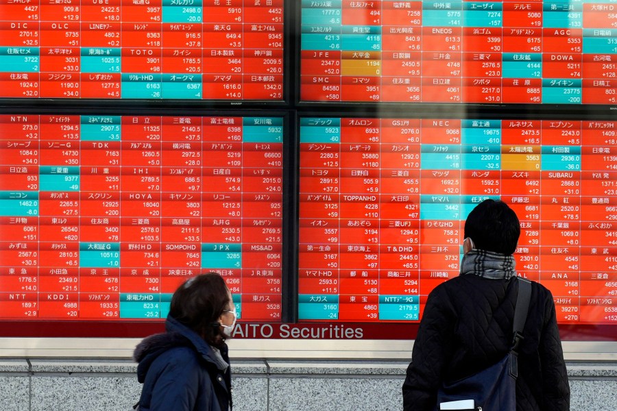 FILE - People look at an electronic stock board showing Japan's stock prices at a securities firm Wednesday, Jan. 17, 2024, in Tokyo. Asian shares were mostly higher Wednesday, Feb. 7, 2024, tracking gains on Wall Street, although Tokyo's benchmark slipped. (AP Photo/Eugene Hoshiko, File)