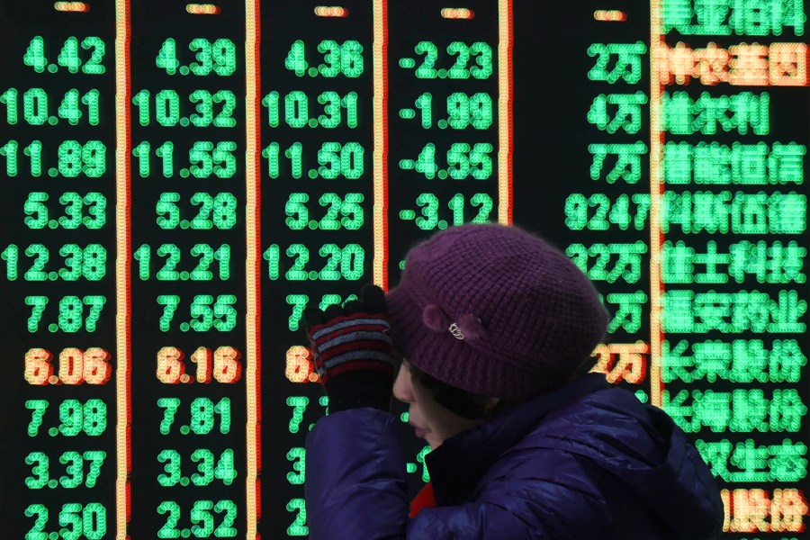 FILE - A woman reacts in front of an electronic screen displaying stock prices at a brokerage house in Hangzhou in east China's Zhejiang province, on Feb. 5, 2024. A Chinese state investment fund has promised to expand its purchases of stock index funds to help markets that have been sagging under heavy selling pressure from a property crisis and slowing economy. (Chinatopix via AP, File)