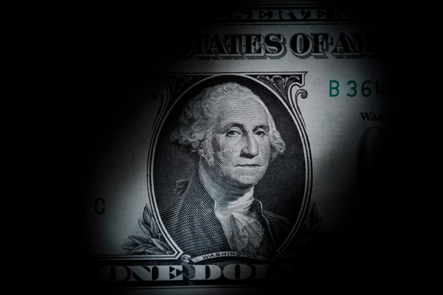 FILE - The likeness of George Washington is seen on a U.S. one dollar bill, March 13, 2023, in Marple Township, Pa. The Congressional Budget Office says it expects the federal budget deficit to drop by $188 billion this fiscal year to $1.5 trillion. But it's likely to be a short-lived dip as the annual shortfall will likely rise over the next nine years. (AP Photo/Matt Slocum, File)