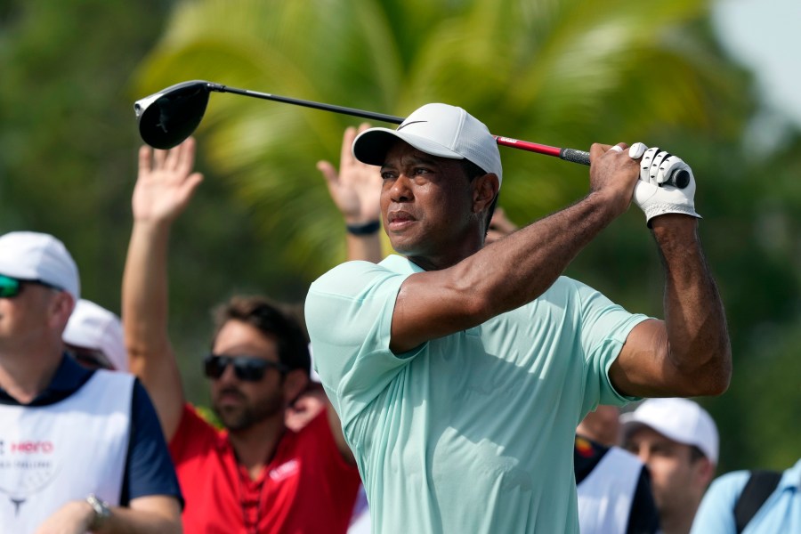 FILE - Tiger Woods watches his shot on the fourth tee during the third round of the Hero World Challenge PGA Tour at the Albany Golf Club, in New Providence, Bahamas, Saturday, Dec. 2, 2023. Tiger Woods confirmed Wednesday, Feb. 7, 2024 he will make his first PGA Tour start since the Masters at the Genesis Invitational next week at Riviera, a tournament he hosts. (AP Photo/Fernando Llano, File)