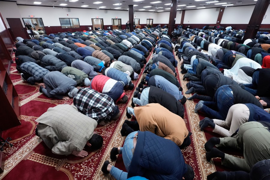 FILE - Men pray at the Islamic Center of Detroit in Detroit, Friday, Jan. 26, 2024. Biden is dispatching several senior aides to Michigan to meet with Arab American and Muslim leaders as the administration’s handling of the Israel-Hamas war continues to frustrate members of a key constituency in a 2024 battleground state. That's according to three people familiar with the matter. (AP Photo/Paul Sancya, File)