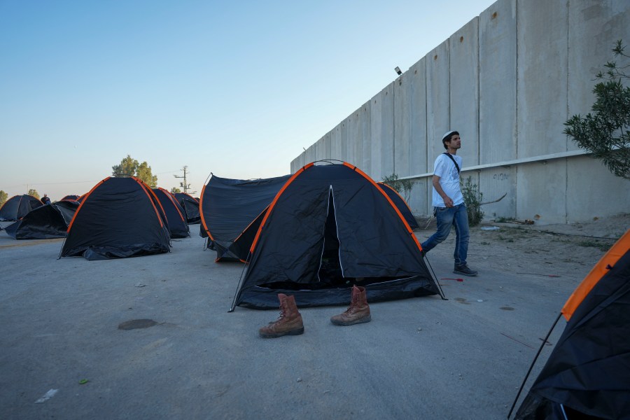 Israeli activists set up tents where they say the spend the night for blocking trucks carrying humanitarian aid into the Gaza Strip at the Kerem Shalom border crossing between Israel and Gaza, in southern Israel, Wednesday, Feb. 7, 2024. The activists say no aid should enter the territory until Israeli hostages held captive by the Hamas militant group are released. (AP Photo/Tsafrir Abayov)