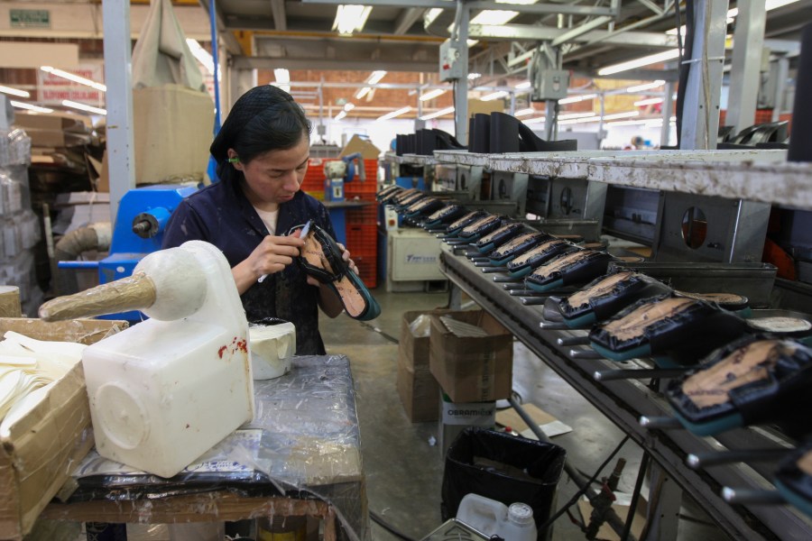 FILE - A woman works in a shoe maquiladora or factory in Leon, Mexico, Feb. 7, 2023. For the first time in more than two decades, Mexico last year overtook China as America's top supplier of goods — a shift that reflects political tensions between Washington and Beijing and U.S. efforts to import from countries that are friendlier and closer to home. (AP Photo/Mario Armas, File)
