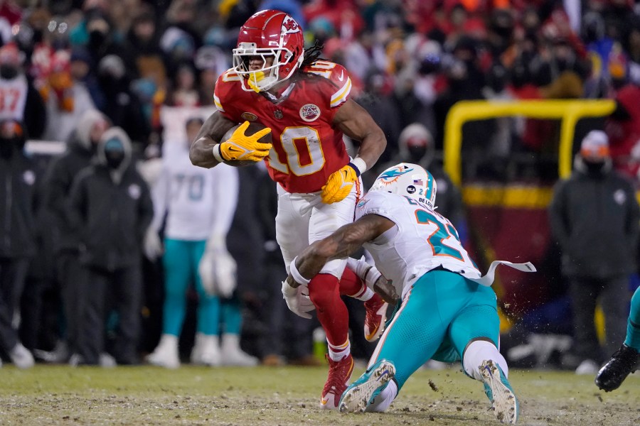 Kansas City Chiefs running back Isiah Pacheco (10) runs against Miami Dolphins safety DeShon Elliott during the first half of an NFL wild-card playoff football game Saturday, Jan. 13, 2024, in Kansas City, Mo. (AP Photo/Ed Zurga)