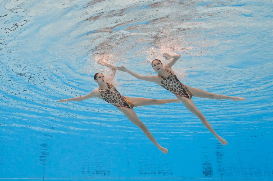 Wang Liuyi and Wang Qianyi, of China, compete in the women's duet free final of artistic swimming at the World Aquatics Championships in Doha, Qatar, Thursday, Feb. 8, 2024. (AP Photo/Lee Jin-man)