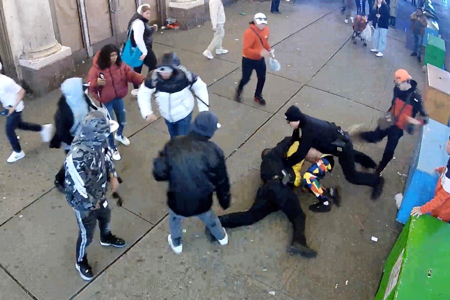 This image from video provided by the Office of the Manhattan District Attorney, Thursday, Feb. 8, 2024, shows the brawl between New York City Police Department officers and migrants in Times Square, Jan. 27, 2024. Manhattan D.A. Alvin Bragg announced six additional indictments of men allegedly involved in a brawl with police officers in Times Square, but he said investigators were still working to identify several suspects and their exact role in the frenzy. (Manhattan District Attorney via AP)