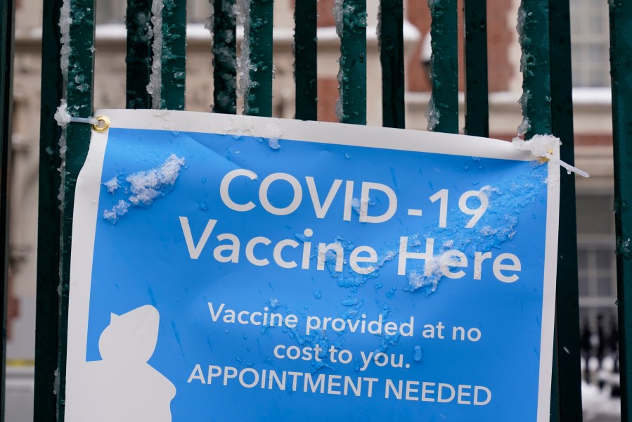FILE - A sign advertises a COVID-19 vaccination site in New York, Feb. 2, 2021. A Brooklyn woman who pleaded guilty to fraud in connection with various pandemic-era relief schemes was sentenced Thursday, Feb 8, 2024, to three years of probation and $650,000 in penalties. (AP Photo/Seth Wenig, File)
