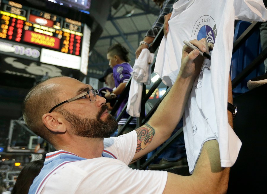 FILE - Former Sacramento Kings player Scot Pollard signs an autograph during the half time of the Kings NBA basketball game against the Oklahoma City Thunder, Saturday, April 9, 2016, in Sacramento, Calif. NBA champion and “Survivor” contestant Scot Pollard has had a heart transplant, his wife said on social media on Friday, Feb. 16, 2024. (AP Photo/Rich Pedroncelli, File)