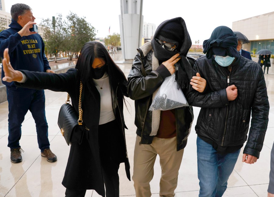 FILE - Former FBI informant Alexander Smirnov, second from right, leaves the courthouse on Feb. 20, 2024, in Las Vegas. A federal judge in California will consider whether Smirnov, who was charged with lying about a multimillion-dollar bribery scheme involving President Joe Biden's family, must remain behind bars while he awaits trial. U.S. District Judge Otis Wright II has set a hearing for Monday, Feb. 26 in Los Angeles on prosecutors' request to keep Smirnov in jail. (Bizuayehu Tesfaye/Las Vegas Review-Journal via AP, File)