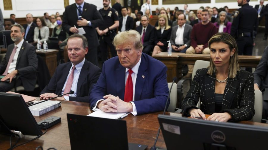 Former President Trump is flanked by his lawyers while in court.