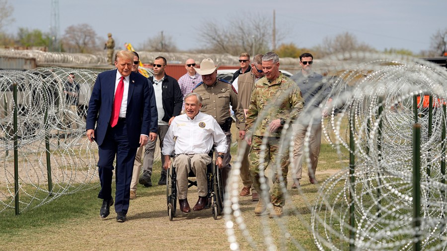 Former President Trump talks with Texas Governor Greg Abbott by the border.