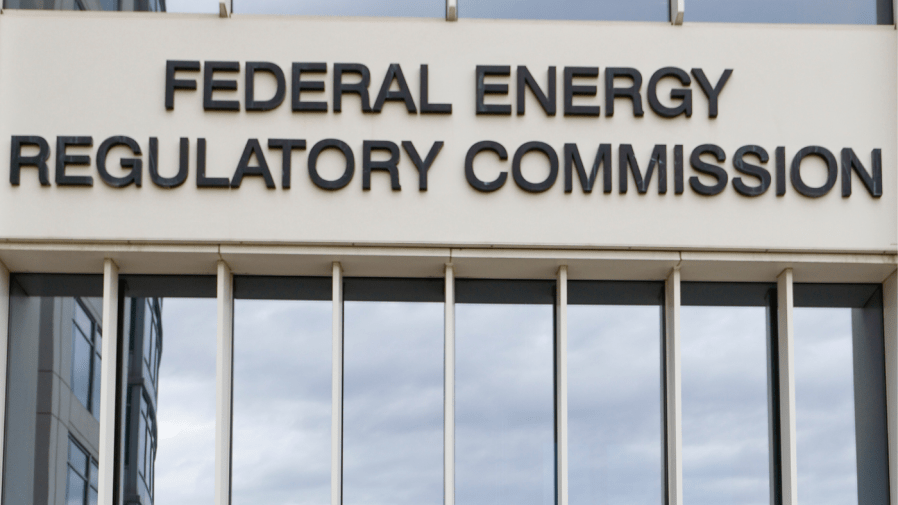 A sign for the Federal Energy Regulatory Commission is seen on a building.