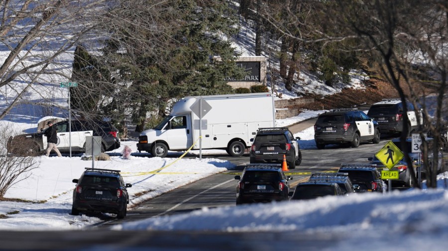 Law enforcement vehicles are parked near the scene where two police officers and a first responder were shot and killed Sunday, Feb. 18, 2024, in Burnsville, Minn.