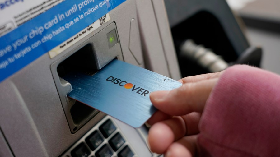 A Discover card is used to pay for gasoline at a Sam's Club in Madison, Miss., July 1, 2021.