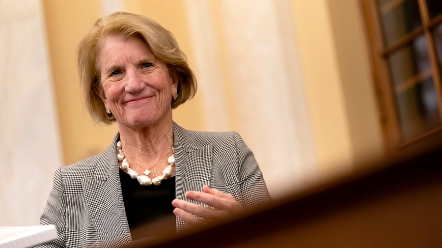 Senator Shelly Moore Capito heads to her seat at a congressional hearing.