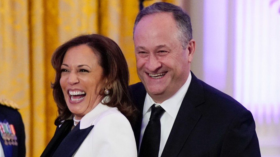 FILE - Vice President Kamala Harris and her husband Doug Emhoff arrive in the East Room of the White House following a dinner reception for the governors and their spouses on Feb. 11, 2023, in Washington.