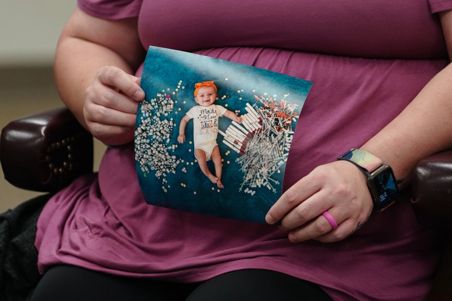 Elizabeth Goldman, an in-vitro fertilization patient at the University of Alabama at Birmingham, holds up a photo of her daughter who was born via the procedure during a roundtable with U.S. Health and Human Services Secretary Xavier Becerra on February 27, 2024 in Birmingham, Alabama.