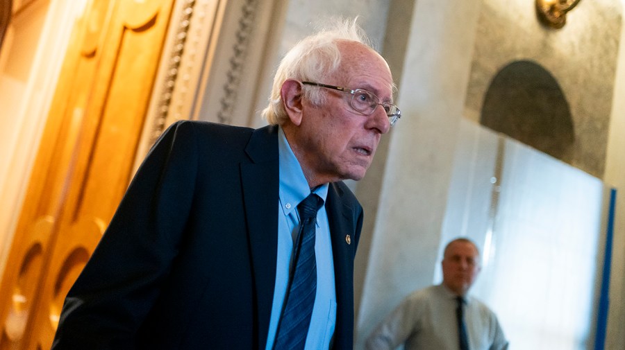 Senator Bernie Sanders leaves the Senate Chamber.