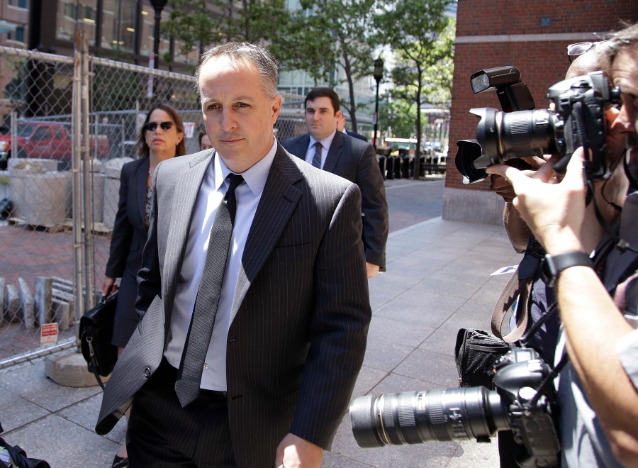 FILE - Barry Cadden, president of the New England Compounding Center, followed by members of his legal team, arrive at the federal courthouse for sentencing, June 26, 2017, in Boston. The co-founder of a specialty pharmacy that was at the center of a deadly national meningitis outbreak in 2012 pleaded no contest to involuntary manslaughter in Michigan, authorities said Tuesday, March 5, 2024. (AP Photo/Stephan Savoia, file)