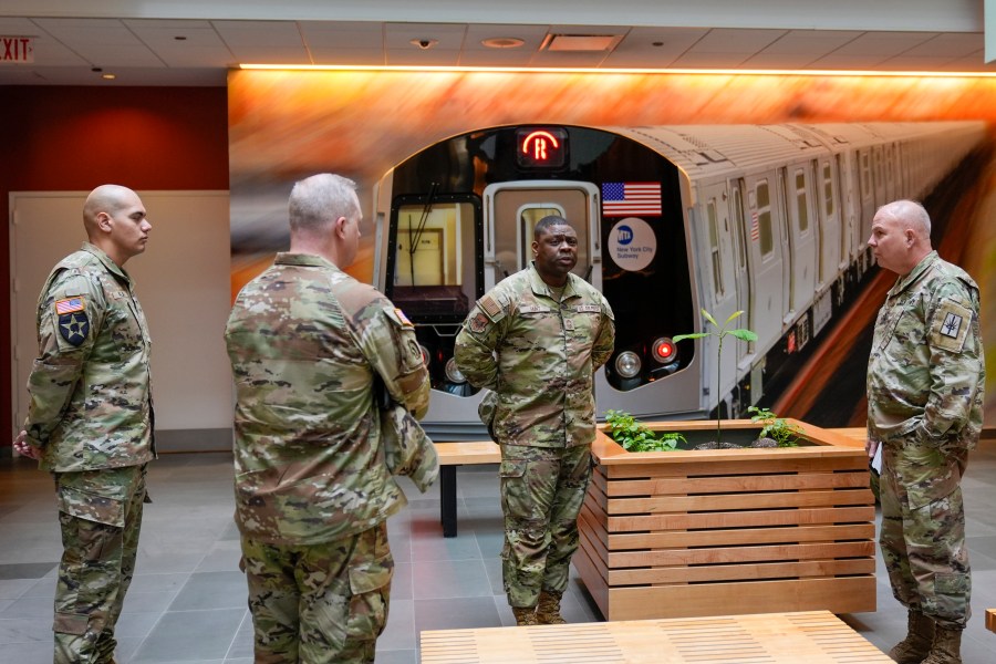 Members of the Armed Forces including the National Guard wait in the lobby of the New York City Mass Transit Authority Rail Control Center before the start of a news conference with Gov. Hochul, Wednesday, March 6, 2024, in New York. Hochul is deploying the National Guard to the New York City subway system to help police search passengers' bags for weapons, following a series of high profile crimes on city trains. (AP Photo/Mary Altaffer)