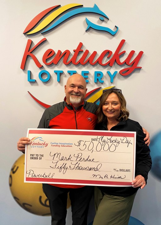 In this recent image provided by Kentucky Lottery, Mark Perdue and his wife pose at the Kentucky Lottery's headquarters in Louisville, Ky. Luck struck twice for the Kentucky couple who thought they lost a winning Powerball ticket. The Bowling Green couple found out about a week after purchasing the ticket in late October that they had won $50,000, but they couldn't find the ticket, the Kentucky Lottery said in a statement. Three months later, Perdue went to check out the condition of a car at work and saw the ticket inside. The couple claimed $36,000 after taxes the following day. (Kentucky Lottery via AP)