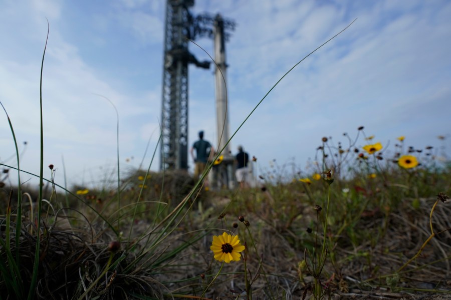 FILE - Visitors look on as SpaceX's Starship, the world's biggest and most powerful rocket, stands ready for a scheduled launch from Starbase in Boca Chica, Texas, Wednesday, April 19, 2023. SpaceX would acquire public land in Texas to expand its rocket launch facilities under a tentative deal that is moving forward after months of opposition from nearby residents and some local officials near the U.S.-Mexico border. (AP Photo/Eric Gay, File)