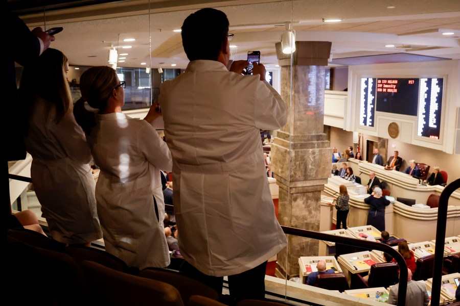 Doctors from the Alabama Fertility Clinic takes photos of the votes as the debate over SB159 bill (IVF Fertility Bill) in the House Chambers is voted on, Wednesday, March 6, 2024, in Montgomery, Ala. (AP Photo/ Butch Dill)