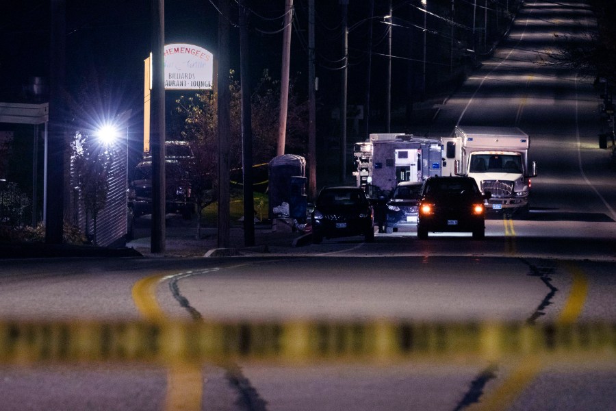 FILE - Police tape cordons off the road to Schemengees Bar and Grille as law enforcement officers maintain their presence in the aftermath of a mass shooting by Army reservist Robert Card in Lewiston, Maine, Oct. 27, 2023. Army officials will testify Thursday, March 7, 2024 before a special commission investigating the deadliest mass shooting in Maine history, which was committed by a former reservist. (AP Photo/Matt Rourke, File)