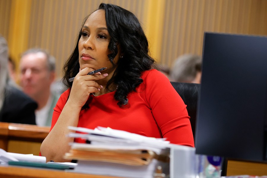 FILE - Fulton County District Attorney Fani Willis looks on during a hearing on the Georgia election interference case, Friday, March, 1, 2024, in Atlanta. A progressive Democrat and a Republican who briefly worked in Donald Trump's administration entered the Fulton County district attorney's race Friday, March 8, 2024, as the current officeholder, Willis, awaits a judge's decision on whether she will be removed from the Georgia election interference case against the former president. (AP Photo/Alex Slitz, Pool, File)