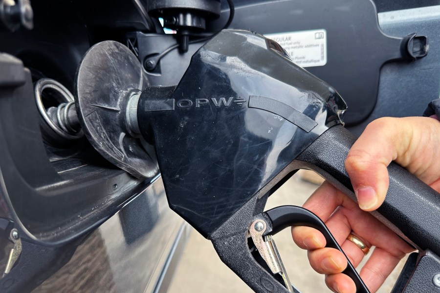 FILE - A costumer pumps gas at a gas station in Mundelein, Ill., Feb. 8, 2024. A Nebraska woman is facing theft charges, accusing her of exploiting a gas pump glitch at a Lincoln, Neb. service station. Authorities say the woman found that by double-swiping a rewards card, she could put the pump into demo mode and get free gas. She's accused of costing the station nearly $28,000 in gas over a seven-month period. (AP Photo/Nam Y. Huh, file)