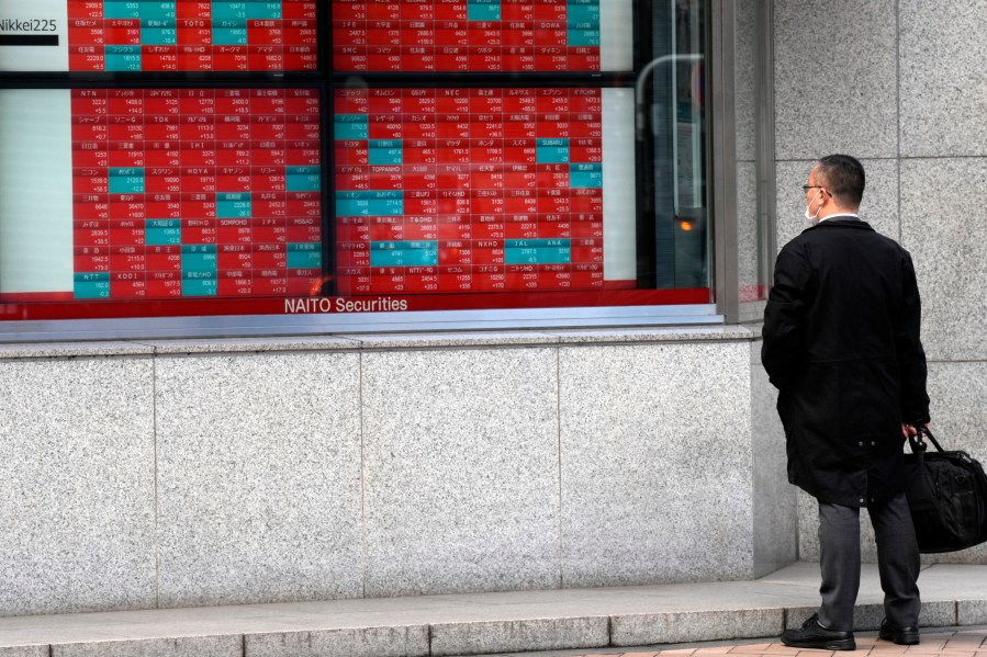 FILE - A person looks at an electronic stock board showing Japan's stock prices at a securities firm Friday, March 1, 2024, in Tokyo. Asian shares mostly rose Wednesday, March 13, encouraged by a record rally on Wall Street that was led by technology companies. (AP Photo/Eugene Hoshiko, File)