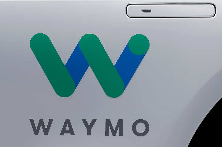 FILE - In this May 8, 2018, file photo, a Waymo logo is displayed on the door of a car at the Google I/O conference in Mountain View, Calif. Robotaxis are hitting the streets of Los Angeles. Google spinoff Waymo says on Thursday, March 14, 2024 it will begin offering free rides to a some of the roughly 50,000 people who have signed up for its driverless ride-hailing service in the second largest U.S. city. (AP Photo/Jeff Chiu, File)