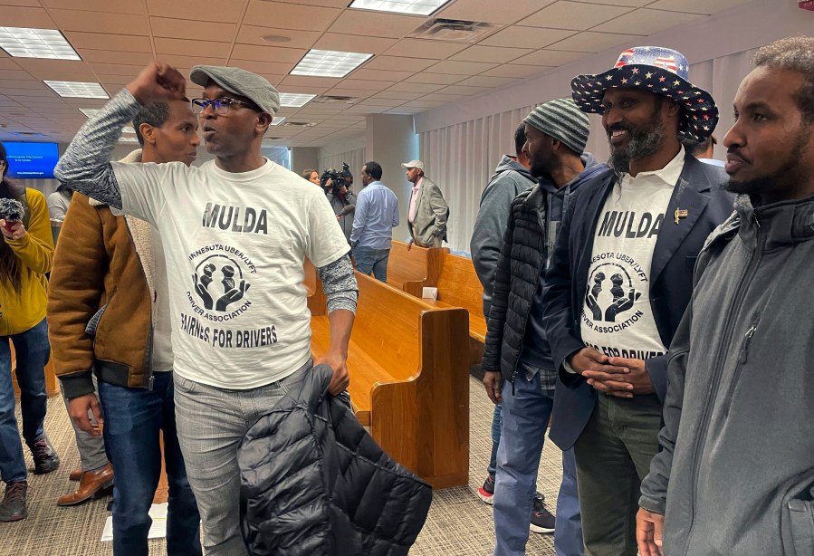 Ride-hailing drivers celebrate in Minneapolis, Thursday, March 7, 2024, immediately after Minneapolis City Council members voted to pass a measure that would increase wages to drivers of ride-hailing companies, including Uber and Lyft, to an equivalent of more than $15 an hour. Opponents say this may increase costs to customers and increase fears that Uber and Lyft will follow through on their threats to leave the area altogether. (AP Photo/Trisha Ahmed)