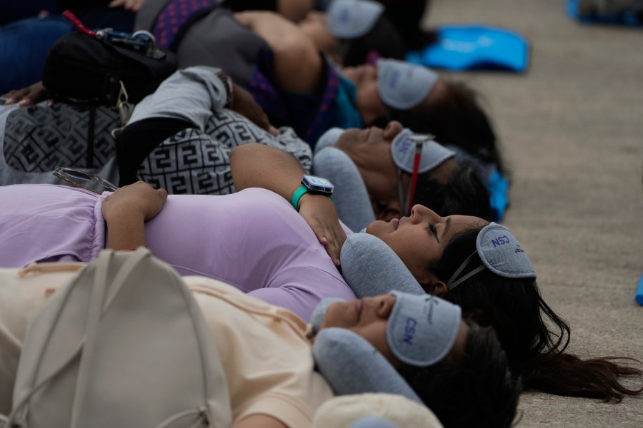 Equipped with mats, sleeping masks and travel pillows, people lie sprawled out at the base of the iconic Monument to the Revolution to take a nap, in Mexico City, Friday, March 15, 2024. Dubbed the “mass siesta,” the event was in commemoration of World Sleep Day. (AP Photo/Fernando Llano)