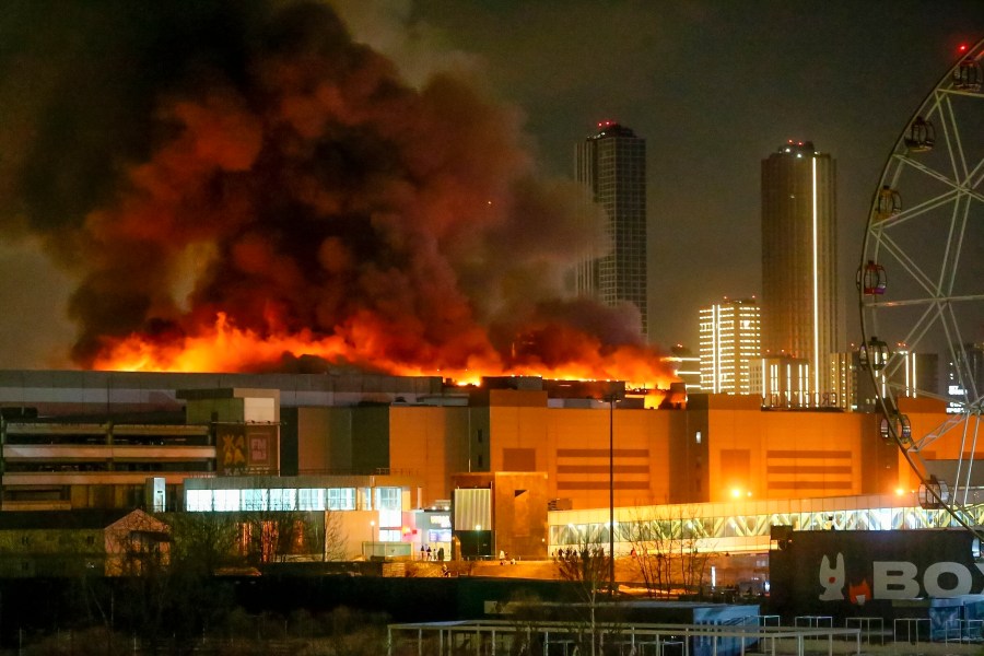 A massive blaze is seen over the Crocus City Hall on the western edge of Moscow, Russia, Friday, March 22, 2024. Several gunmen have burst into a big concert hall in Moscow and fired automatic weapons at the crowd, injuring an unspecified number of people and setting a massive blaze in an apparent terror attack days after President Vladimir Putin cemented his grip on the country in a highly orchestrated electoral landslide. (Sergei Vedyashkin/Moscow News Agency via AP)