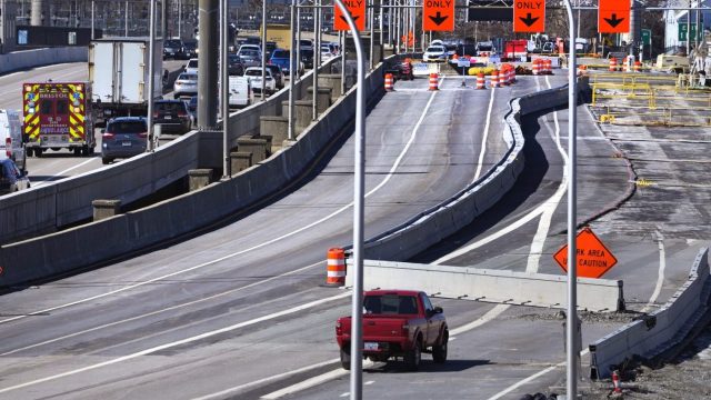 Diverted traffic, including an ambulance on a call, passes a closed portion of the Washington Bridge, Friday, March 8, 2024, in East Providence, R.I. The closure of a section of the bridge, and onramps, due to failure of some bridge components, has caused a significant loss to local businesses. (AP Photo/Charles Krupa)