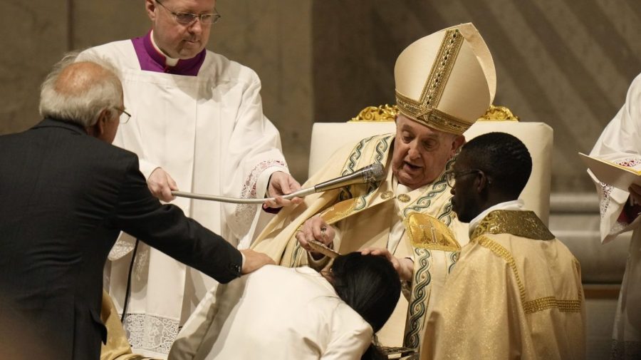 Pope Francis baptises a faithful as he presides over the Easter vigil celebration in St. Peter's Basilica at the Vatican, Saturday, March 30, 2024. (AP Photo/Alessandra Tarantino)