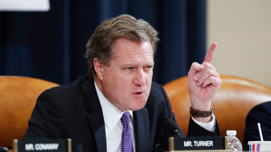 Representative Mike Turner gestures while speaking during a committee hearing.