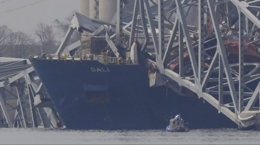 A container rests against wreckage of the Francis Scott Key Bridge.