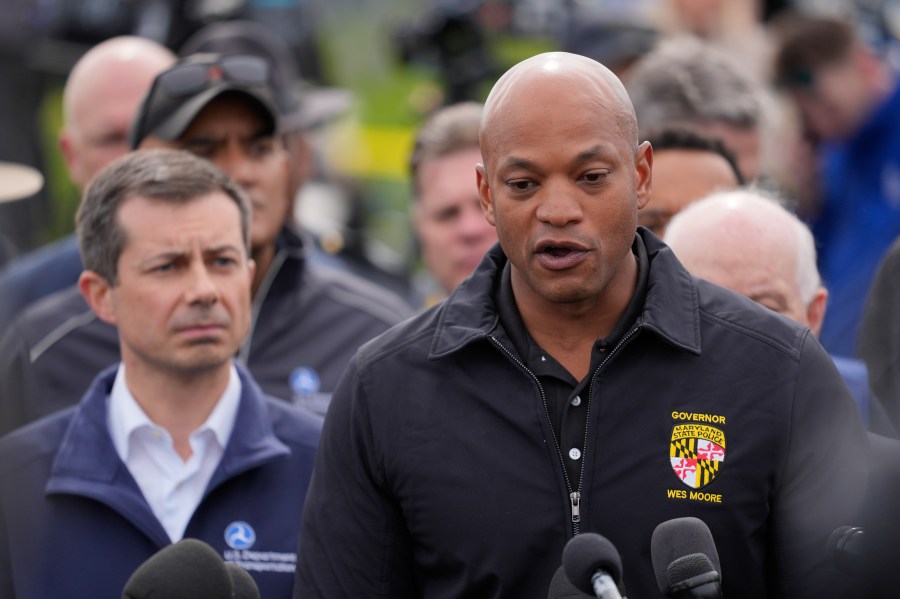 Pete Buttigieg and other officials standby as Maryland Governor Wes Moore delivers a speech about the Francis Scott Key Bridge crash.