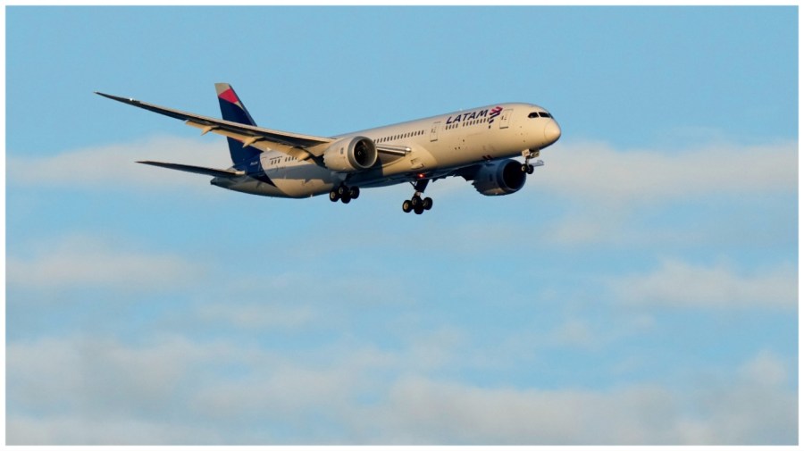 A LATAM Airlines Boeing 787 approaches for landing in Lisbon at sunrise, Wednesday, July 5, 2023. (AP Photo/Armando Franca)