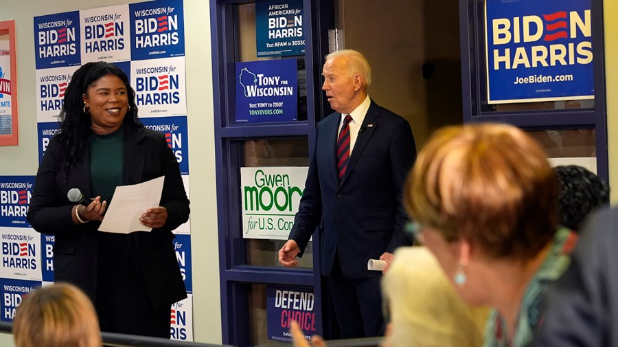 President Joe Biden faces a crowd in his Wisconsin election campaign office.