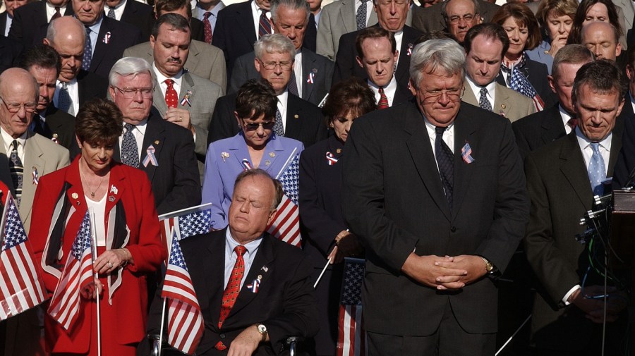 Members of Congress bow their heads in silence on Capitol Hill Wednesday, Sept. 11, 2002, to mark the anniversary of the September 11th attacks. In front row, left to right, are: Rep. Shelley Berkley, D-Nev., Sen. Max Cleland, D-Ga., House Speaker Dennis Hastert, R-Ill., and Senate Majority Leader Tom Daschle, D-S.D.