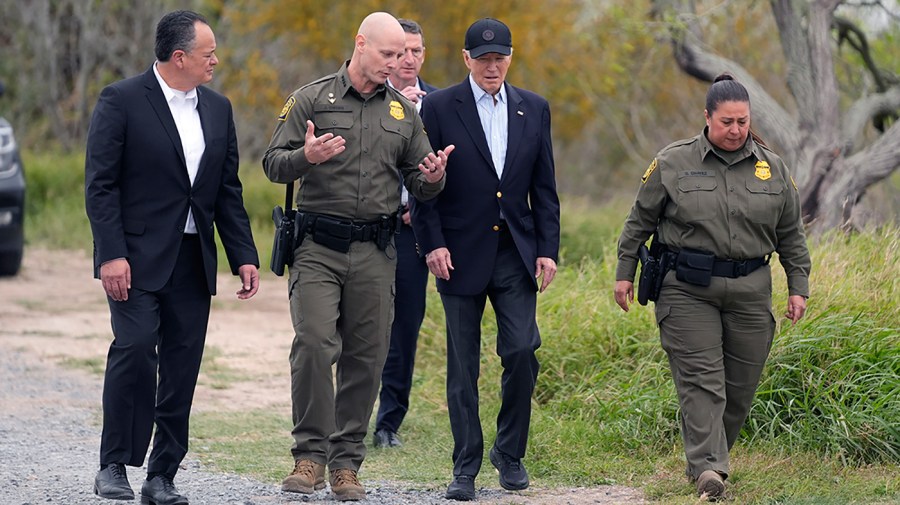 President Biden walks with U.S. Customs and Border Protection officials.